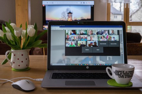 Laptop mit Zoom-Meeting und Kirche